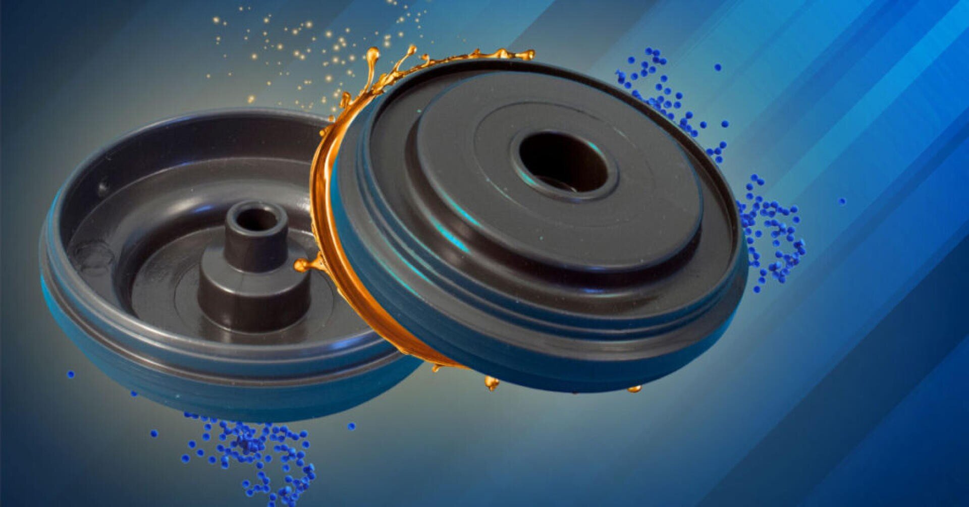 Zwei schwarze, kreisförmige Industriekomponenten sind vor einem blauen Hintergrund mit Farbverlauf abgebildet, wobei sie von orangefarbenen und blauen Flüssigkeitsspritzern oder Partikeln umgeben sind, die einen dynamischen Effekt erzeugen.